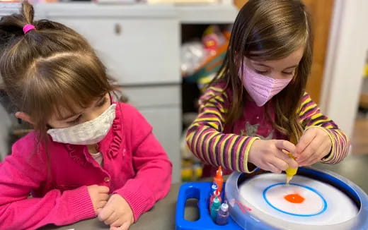 a couple of young girls playing with toys