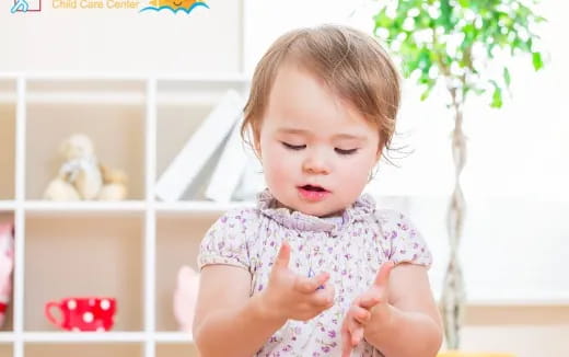 a baby with her hands up
