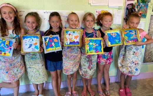 a group of children holding up books