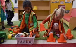 a person and a child playing with toys