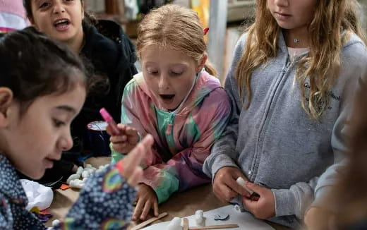 a group of children looking at a paper