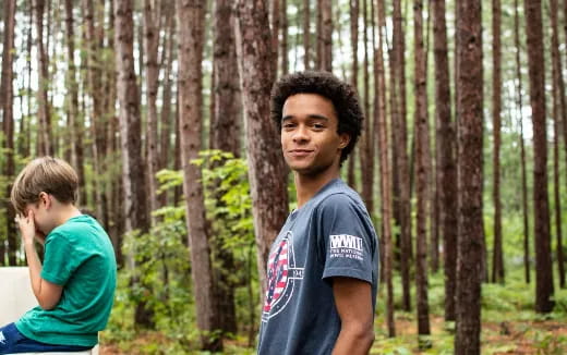 a man standing in a forest