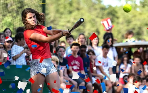 a person hitting a ball with a bat