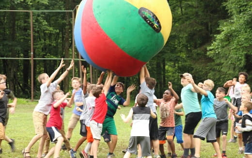 a group of kids playing with a ball