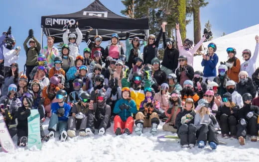 a group of people posing for a photo in the snow