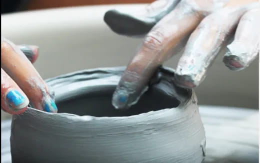 a person pouring liquid into a container