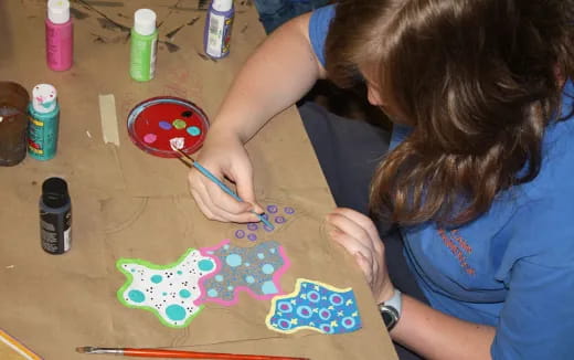 a girl painting on a table