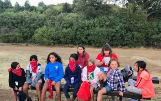 a group of children sitting on a bench