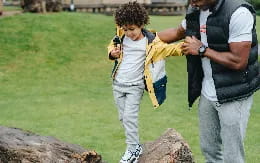 a boy holding a small snake