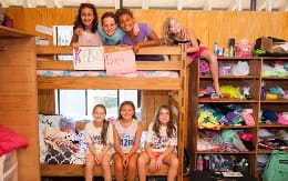 a group of children sitting on a shelf