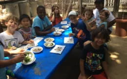 a group of people sitting around a table eating food