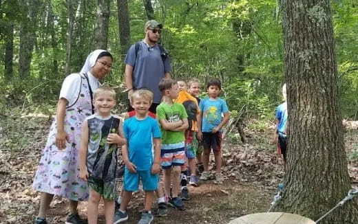 a group of people standing in the woods