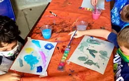 children painting on a table