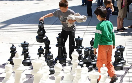 a couple of boys playing chess