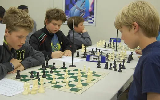 a group of boys playing chess
