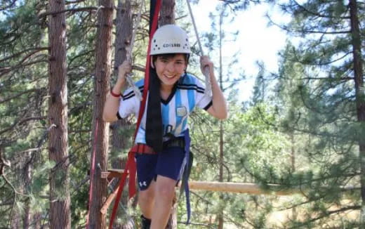 a woman wearing a helmet and harness