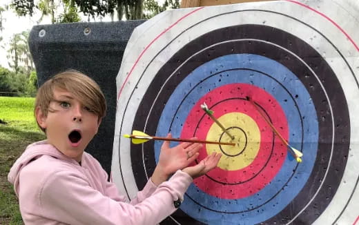 a boy holding a clock