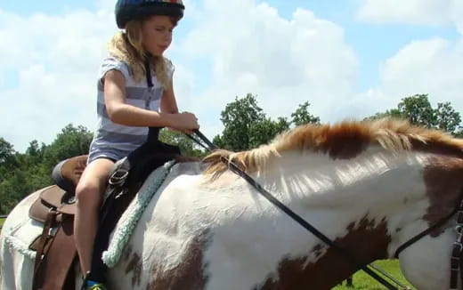 a girl riding a horse