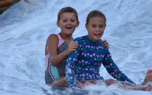 two girls on a surfboard