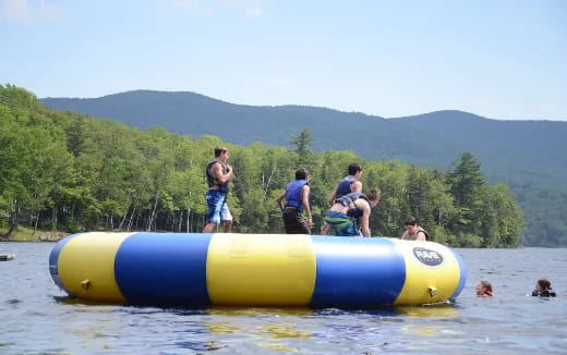 a group of people on a raft in a lake