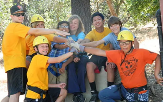 a group of people wearing helmets and harnesses
