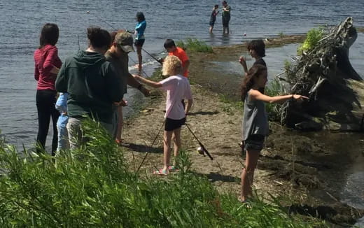 a group of people standing on a beach