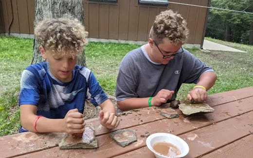 a couple of boys playing with sand