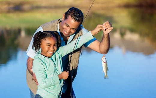 a man and a woman holding a fish