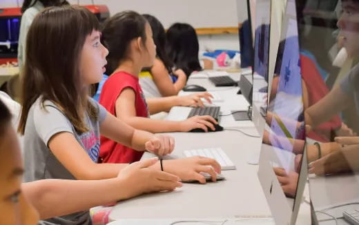 a group of people working on computers