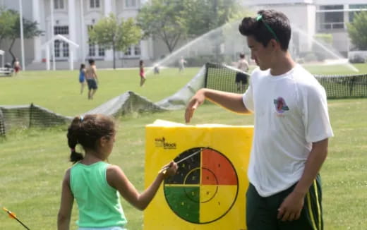 a man and a girl playing football