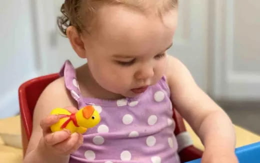 a baby holding a toy