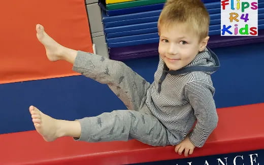 a baby sitting on a red surface