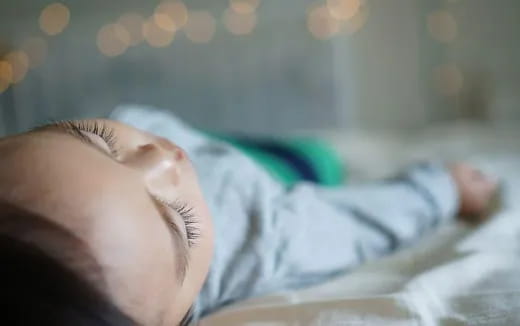 a baby sleeping on a bed