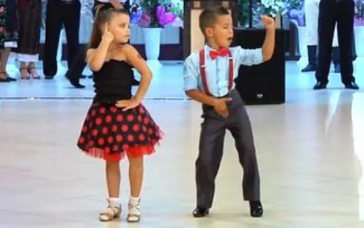 a boy and girl dancing