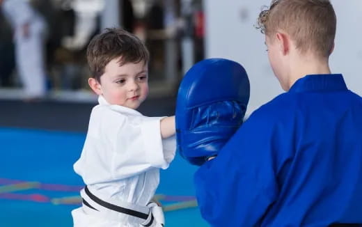 a boy holding a blue ball