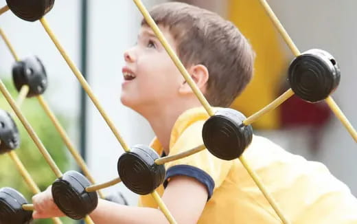 a boy holding a group of microphones