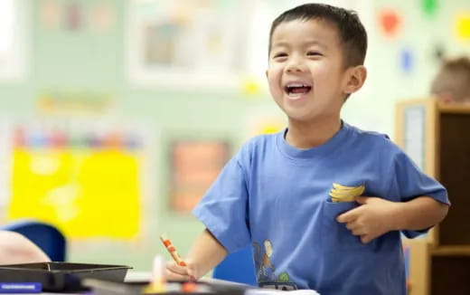 a boy holding a pencil