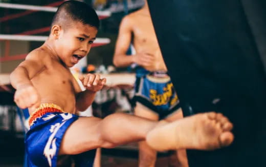 a boy in a wrestling uniform