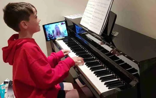 a boy playing a piano