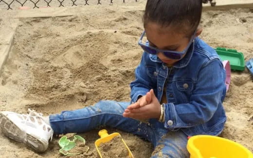 a boy playing in the sand
