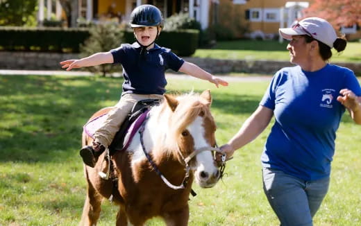 a boy riding a horse