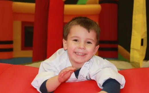 a boy sitting on a red chair