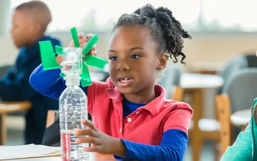 a child holding a bottle