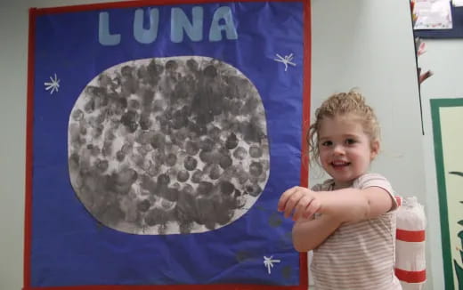 a child holding a rock
