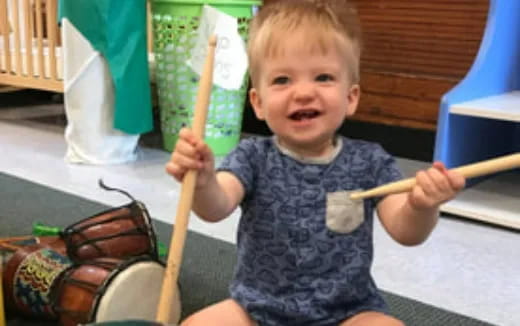 a child holding baseball bats