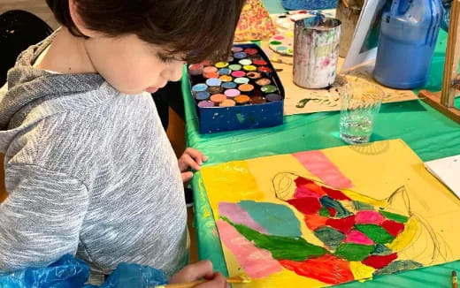 a child painting on a table
