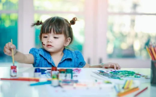 a child painting on a table