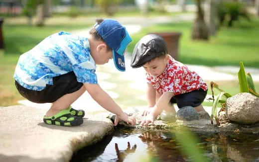 a couple of children planting plants