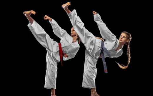 a couple of people in karate uniforms