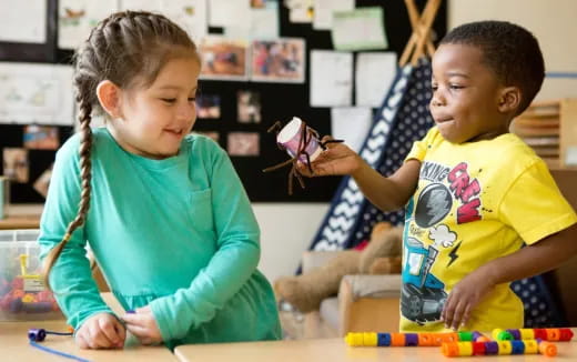 a few young children playing with a toy